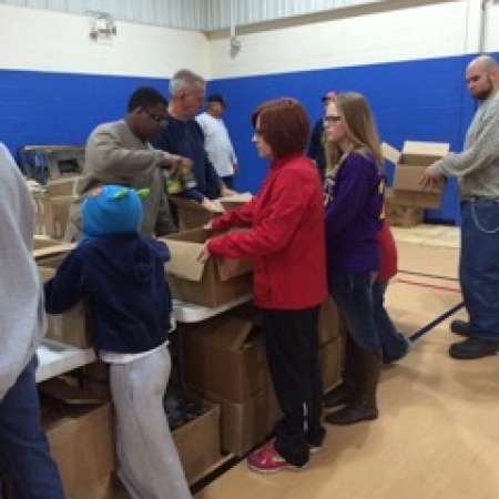 Group works to pack boxes.