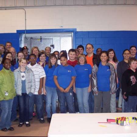 Students, parents, and mentors volunteer at the Salvation Army.