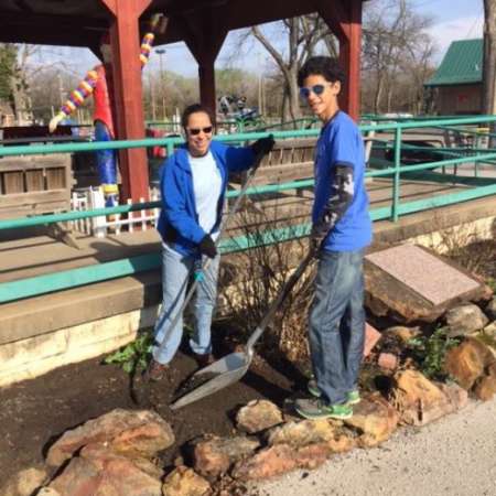 Students, parents, and mentors clean up Kiddie Park before opening.
